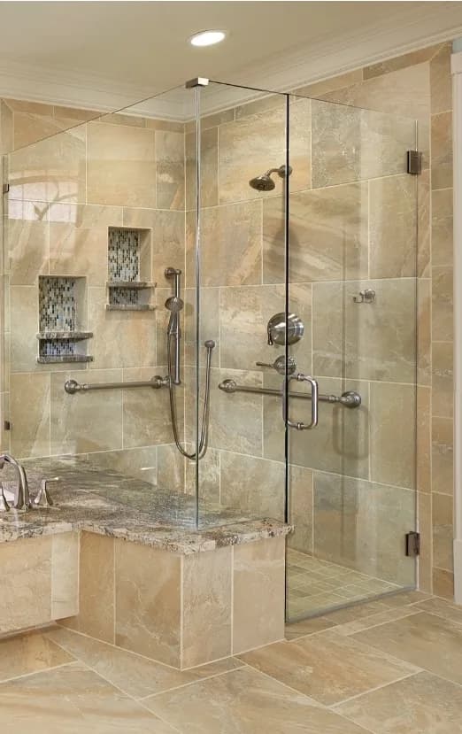 Luxury accessible walk-in shower with marble finishes, frameless glass, and integrated grab bars